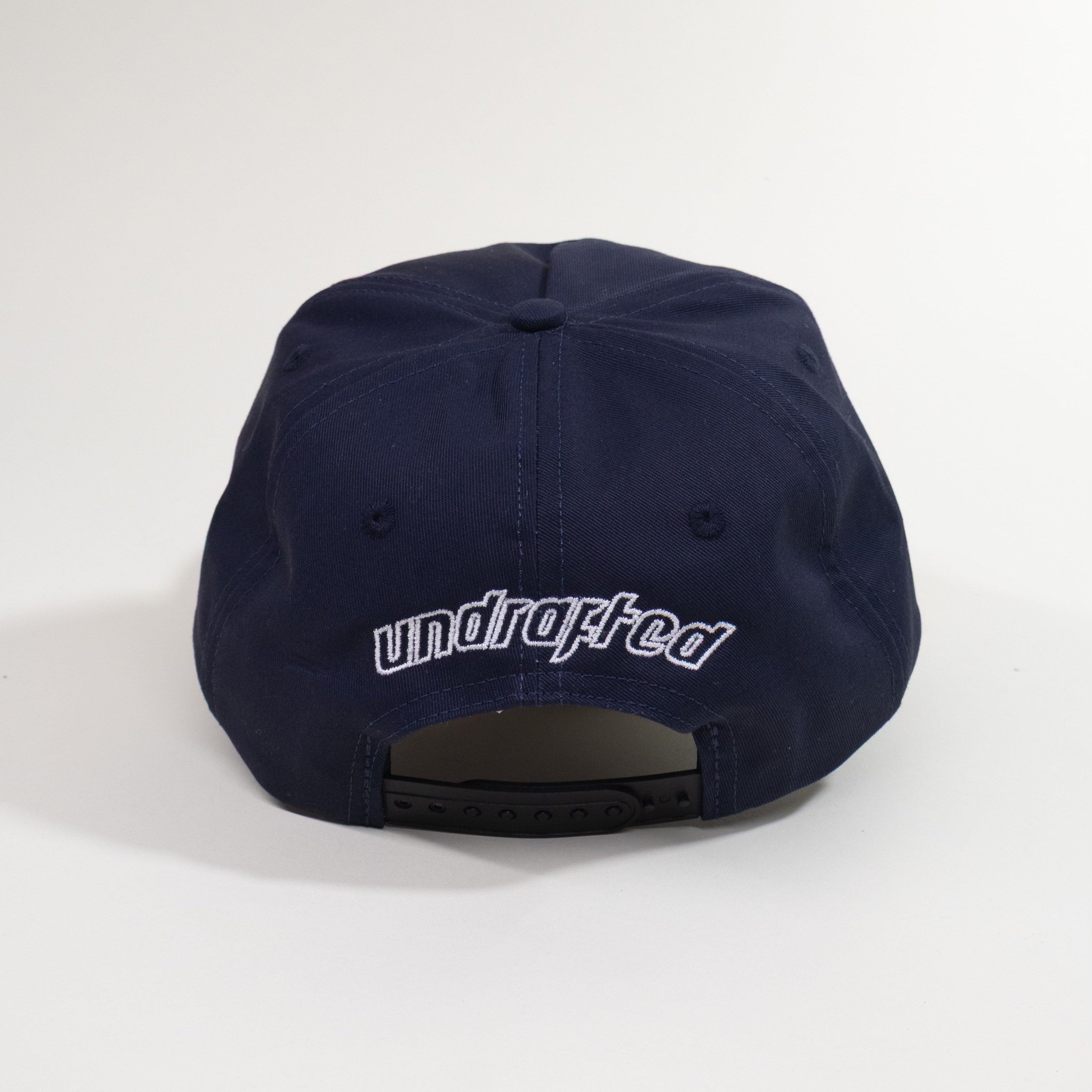 Navy blue cap with 'undrafted' logo on a white background