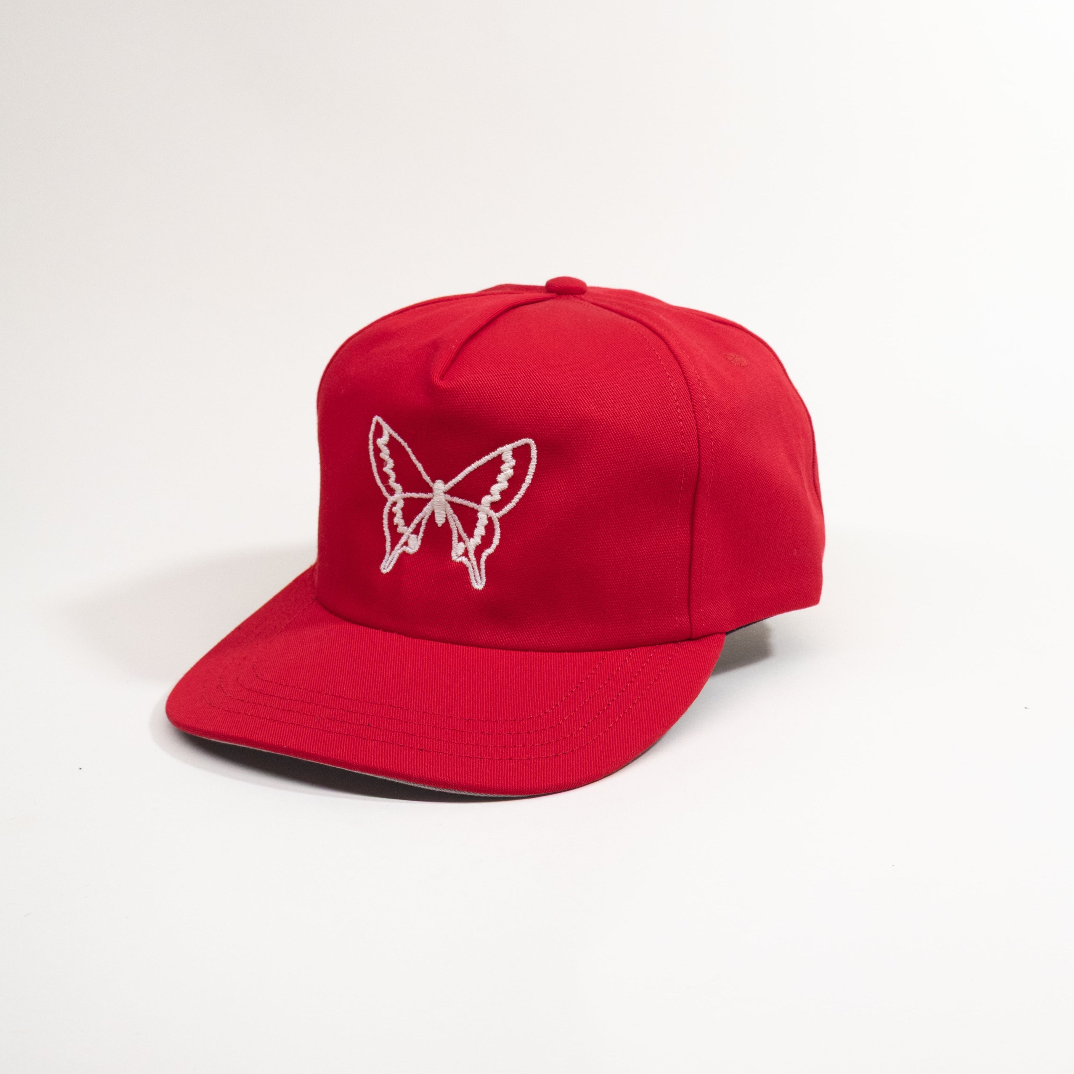 Red cap with a white butterfly logo on a light gray background